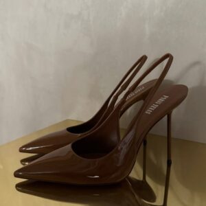 Paris Texas brown patent leather slingback stiletto pumps with pointed toe and slim metal heel on a gold surface